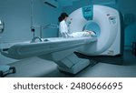 Patient in white clothes undergoes magnetic resonance imaging scan, laying down on bed for CT or PET scan, oncology machine scanning her body. Magnetic resonance diagnostics x-ray.