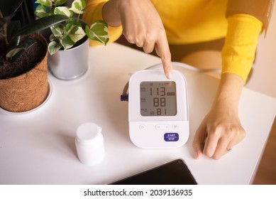 Patient Woman Using Blood Pressure And Heart Rate Monitor For Yourself At Home