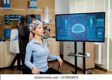 Patient Woman Who Is Brain Scanned And His Activity Is Shown On Screen. Brain Waves Scanning Helmet