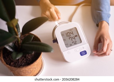 Patient Women Using Blood Pressure And Heart Rate Monitor For Yourself At Home