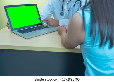 Patients Consult Doctor In Hospital Or Clinic About Sick, With Doctor Point Finger To Laptop Computer Green Screen,concept Of Medical And Technology Treatment