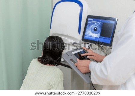 Patients and doctors using visual acuity and fundus examination equipment in ophthalmology.