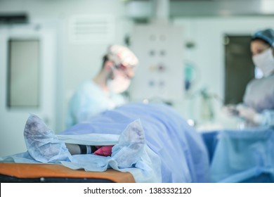 patient's feet on the background of surgery. concept of medical error and mortality in medicine - Shutterstock ID 1383332120