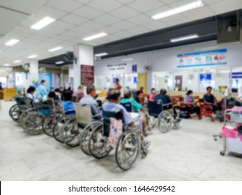 Patients On Wheelchair Waiting For Seeing Doctor At The Outpatient Department In Hospital, Blurred Background.