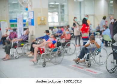 Patients On Wheelchair Waiting For Seeing Doctor At The Outpatient Department In Hospital, Blurred Background.