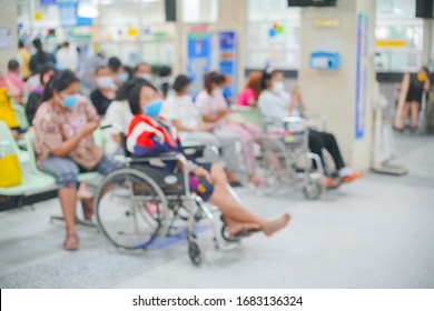 Patients On Wheelchair Waiting For Seeing Doctor At The Outpatient Department In Hospital, Blurred Background.