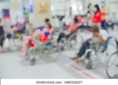 Patients On Wheelchair Waiting For Seeing Doctor At The Outpatient Department In Hospital, Blurred Background.