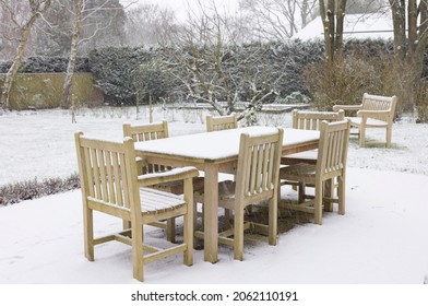 Patio Garden Furniture, Wooden Table And Chairs Covered With Snow In Winter, UK