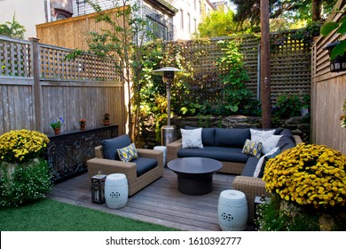 Patio. Garden. Urban, Neutral, Outdoor Living Space. Exterior Photo. Outdoor Living Room With Couch, Comfy Cushions, Throw Pillows, Love Seat, Chairs And Coffee Table. Backyard With Greenery, Plants.