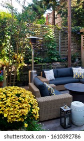 Patio. Garden. Urban, Neutral, Outdoor Living Space. Exterior Photo. Outdoor Living Room With Couch, Cushions Pillows, Love Seat, Chairs And Coffee Table. Backyard With Greenery, Plants And Flowers.