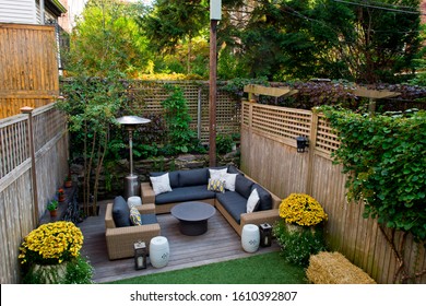 Patio. Garden. Urban, Neutral, Outdoor Living Space. Exterior Photo. Outdoor Living Room With Couch, Comfy Cushions, Throw Pillows, Love Seat, Chairs And Coffee Table. Backyard With Greenery, Plants.