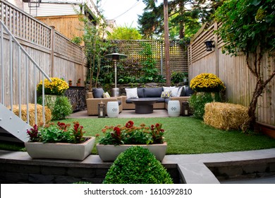 Patio. Garden. Urban, Neutral, Outdoor Living Space. Exterior Photo. Outdoor Living Room With Couch, Comfy Cushions, Throw Pillows, Love Seat, Chairs And Coffee Table. Backyard With Greenery, Plants.