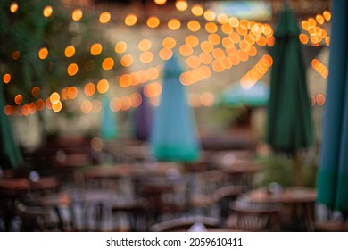 Patio Lights Festive Atmosphere In Outdoor Restaurant Space With Tables And Chairs Furniture Objects Ready For Celebration Event, No People 