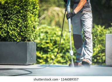 Patio Pressure Cleaning. Caucasian Men Washing His Concrete Floor Patio Using High Pressured Water Cleaner. - Shutterstock ID 1146089357