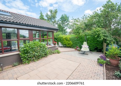 Patio And Sunroom To The Rear Of A Modern Bungalow House.