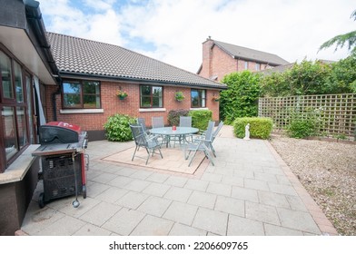 Patio And Sunroom To The Rear Of A Modern Bungalow House.