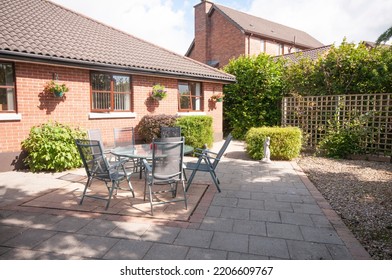 Patio And Sunroom To The Rear Of A Modern Bungalow House.