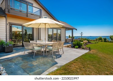 Patio Terrace With Furniture Umbrella And An Ocean View