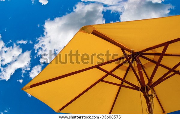 Patio umbrella against\
sunny blue sky