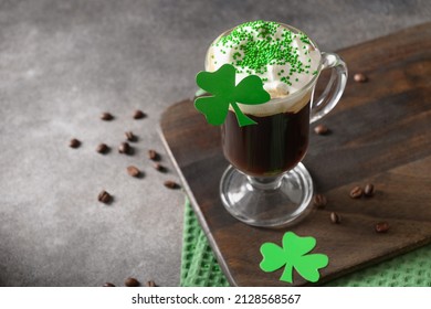 Patrick's Day and celebration with Irish coffee in glass cup with green sprinkles on gray background. Close up. Copy space. - Shutterstock ID 2128568567