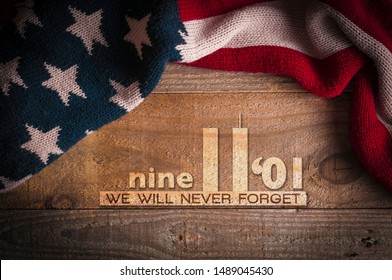 Patriot day 2019: A scarf with the colors of the American flag on a wooden table and an inscription in memory of September 11th