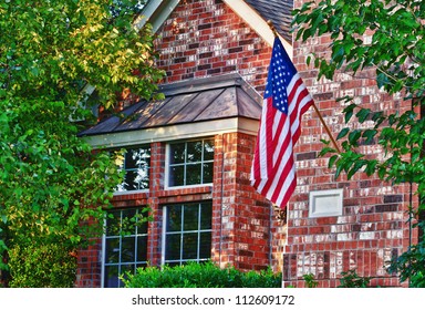 Patriotic American Flag In Front Of Southern Home