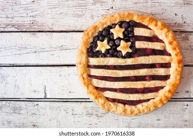 Patriotic American Flag Pie With Cherries And Blueberries. Above View On A Rustic White Wood Background. Fourth Of July Food Concept.