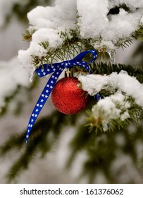 Patriotic Christmas Ornament On A Snowy Pine Tree