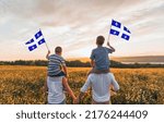 A Patriotic family waving Quebec flags on sunset