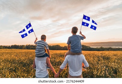 A Patriotic Family Waving Quebec Flags On Sunset