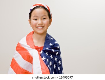 Patriotic Girl With American Flag Around Her Shoulders And American Flag Headband