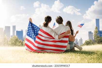 Patriotic holiday. Happy family, parents and daughter child girl with American flag outdoors. The USA celebrate 4th of July. - Powered by Shutterstock