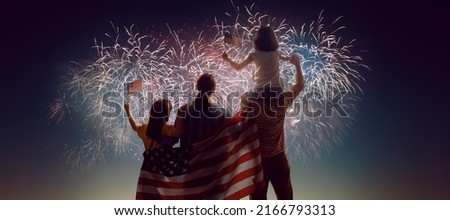 Patriotic holiday. Happy family, parents and daughters children girls with American flag outdoors. USA celebrate 4th of July.