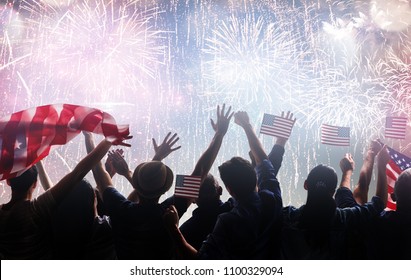 Patriotic holiday. Silhouettes of people holding the Flag of the USA. America celebrate 4th of July.