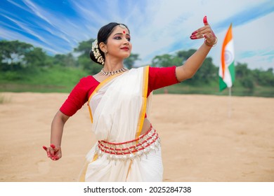 Patriotic Indian classical dancer posing. Culture and traditions of India. Wearing saree. Indian tricolor Flag, Republic Day Concept, Independence day India.