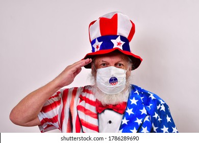 Patriotic Old Man Wearing A Face Mask With A I Voted Sticker, Uncle Sam Hat And Patriotic Shirt Giving A Hand Salute. 
Person Voting
People Voting
Voting In The National Election
