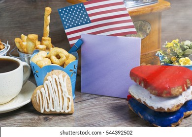 Patriotic party Concept -  Heart shaped cookies color red, blue, white. Cup of coffee (tea), USA flag, decoration on old wooden table. toned filter image. space for text - Powered by Shutterstock