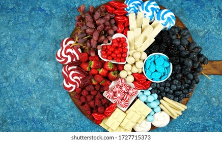 Patriotic Red White And Blue Charcuterie Dessert Grazing Platter With Fruit, Chocolate And Candy For Independence And National Holiday Celebrations. Negative Copy Space.