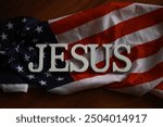 Patriotic Religious Imagery: JESUS Text Overlaid on American Flag Background