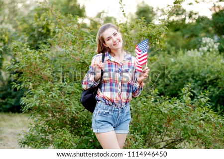 Patriotic student girl holding American flag. 4th of july. Independence Day (United States) 