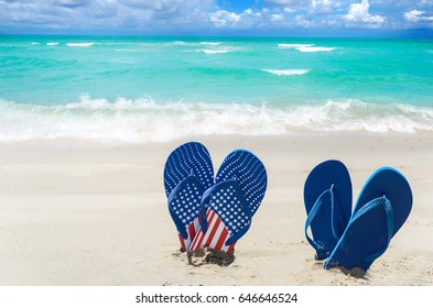 Patriotic USA Background With Flip Flops And Decorations On The Sandy Beach