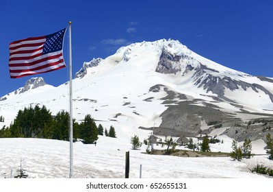 Patriotic view of American Flag with Snow covered Mount Hood, volcano and popular recreation area near Portland Oregon, USA