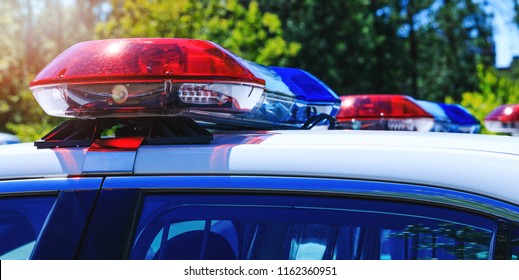 Patrol Police Car With Beautiful Emergency Sirens Lights. Canadian Policemen In Traffic Control Activity. A Police Raid For Arrest And Stop Of Crime Delinquents. Flashing Light On Security Cars.