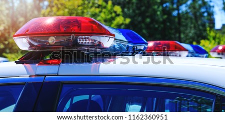 Patrol police car with beautiful emergency sirens lights. Canadian policemen in traffic control activity. A police raid for arrest and stop of crime delinquents. Flashing light on security cars.