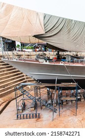 A Patrol Vessel Or Military Vessel Building In A Dry Dock At A Naval Shipyard.