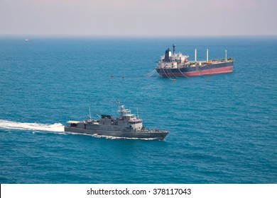 Patrol Vessel Sailing Pass Oil Tanker Ship