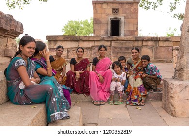 Pattadakal, Karnataka, India - April 24 2013: Extended Indian Family Sitting Outside Temple Taking A Rest From Temple Touring