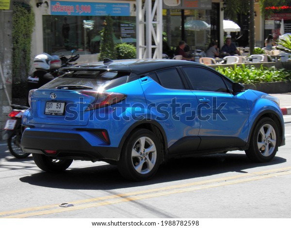 Pattaya, Chonburi province, Thailand - february 16\
2020: private awd all-wheel drive blue metallic color japanese\
midsize crossover 4x4 4wd Toyota C-HR Thai, car SUV driving on\
sunny summer street