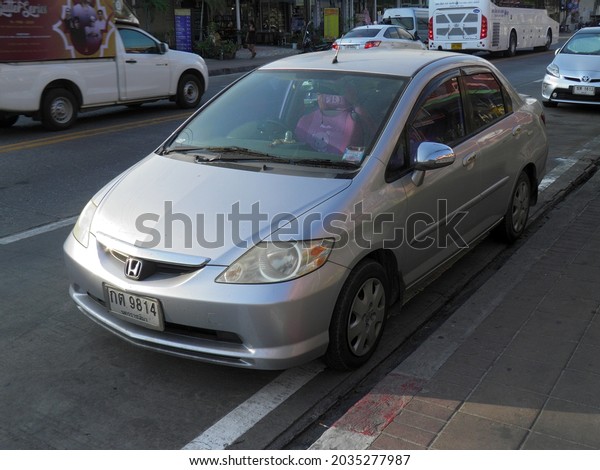 Pattaya, Chonburi province, Thailand -\
february 13 2020: private fwd silver gray metallic color japanese\
compact subcompact small sedan Honda City Thai (Fit Aria), car\
parking on sunny summer\
street\
\
