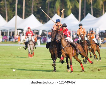PATTAYA - JANUARYÂ 19: Players fighting for the ball during the final between Thai Polo wearing orange and Axus wearing red shirts at Thai Polo Open on JanuaryÂ 19, 2013 in Pattaya, Thailand.